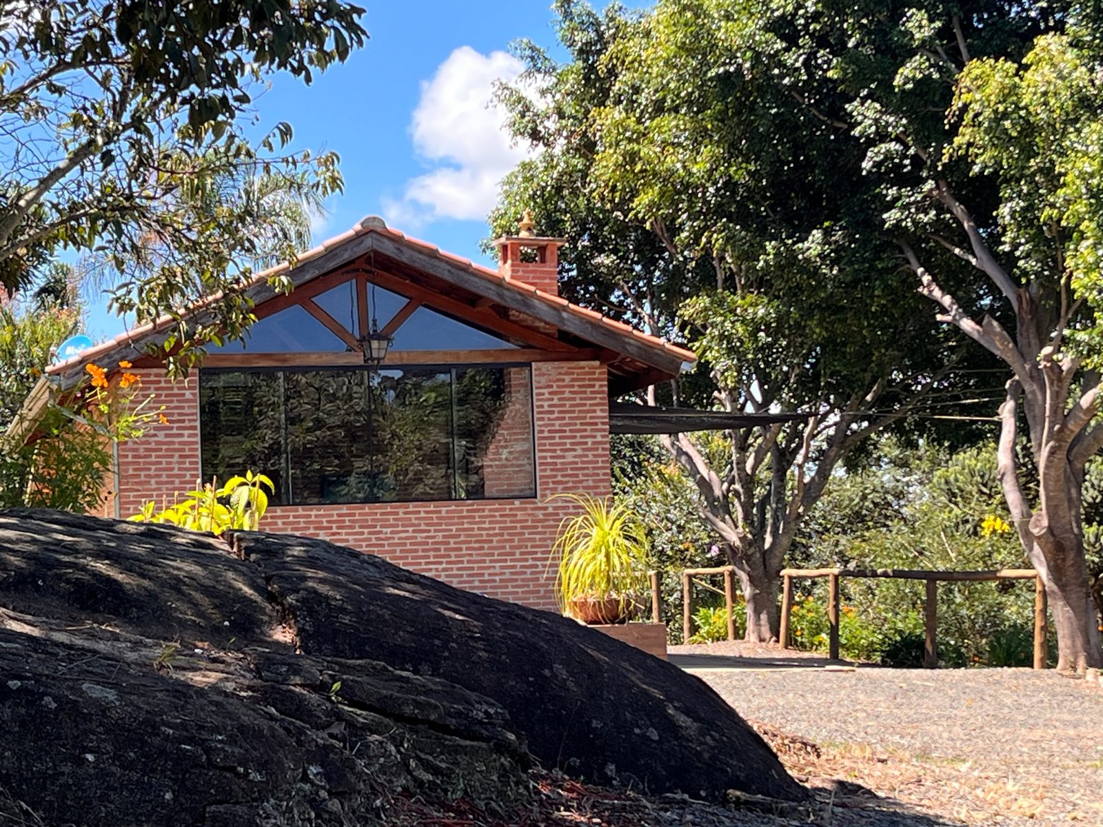 Cabana Terrinha com grandes janelas de vidro voltadas para o vale